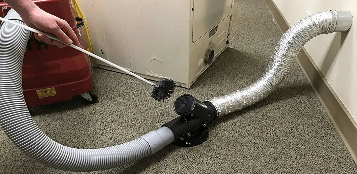 Dryer vent cleaning service removing lint from a dryer duct connection in South Bend, IN