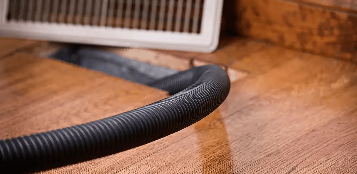 Air duct cleaning hose inserted into a floor vent for ductwork cleaning in South Bend, IN